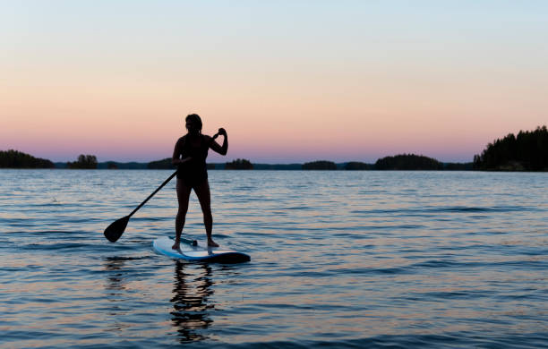 istock Woman on the paddleboard at sunset 1035175896