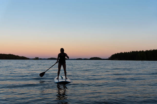istock Woman on the paddleboard at sunset 1035175898