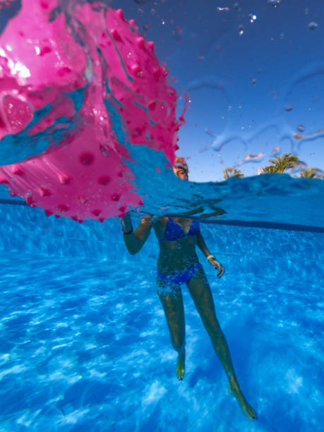 istock Woman Having Fun In The Swimming Pool 1035181012