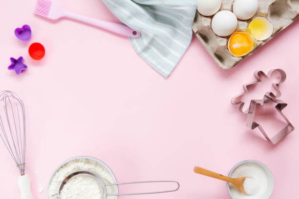 istock Dessert ingredients and utensils on pink pastel background 1035181888