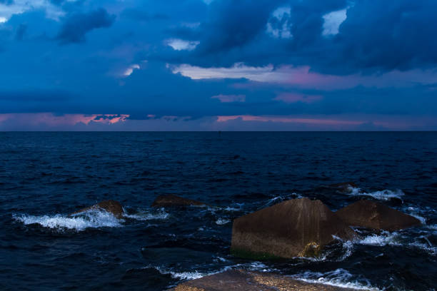 istock Granite wavebrakers in a Gulf of Riga, Latvia after sunset 1035184678
