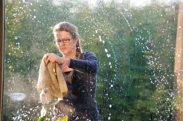 istock Woman cleaning window 1035185244