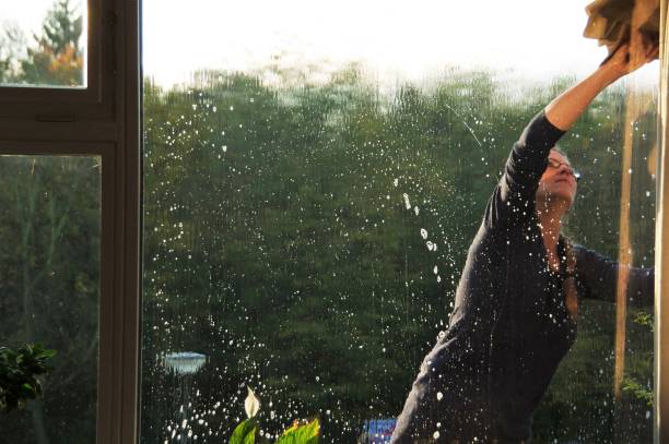 Woman cleaning window