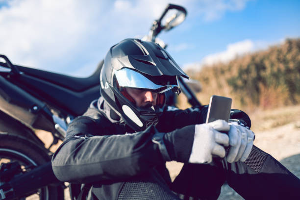 Motorcyclist Adjusting the Navigation on Mobile Phone