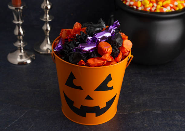 istock Pumpkin Bucket Filled with Various Wrapped Candies 1035188002