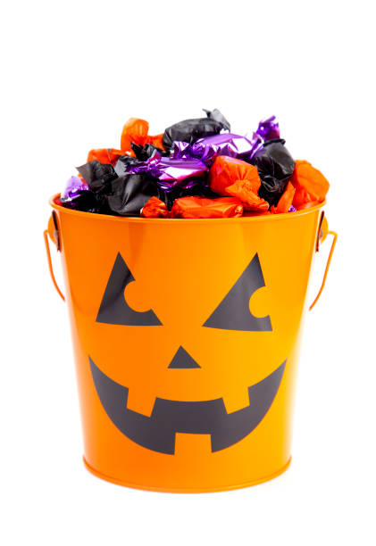 istock Pumpkin Bucket Filled with Various Wrapped Candies 1035188006