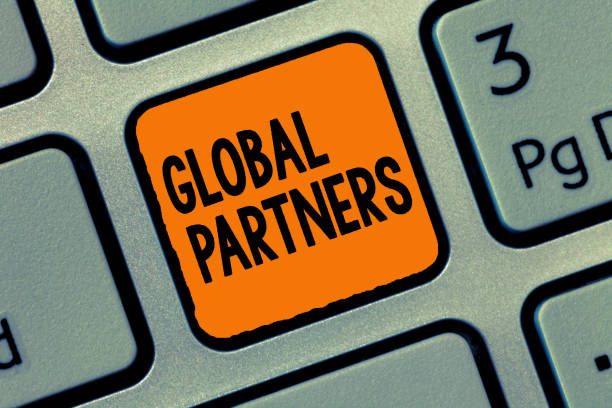 istock Handwriting text writing Global Partners. Concept meaning Two or more firms from different countries work as a team 1035194696