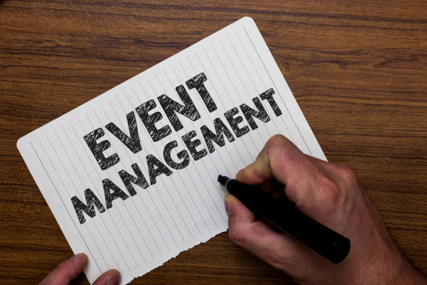 istock Writing note showing  Event Management. Business photo showcasing creation and development of large scale actions festivals Man holding marker notebook paper expressing ideas wooden background. 1035197206
