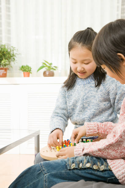 Chinese kids playing Chinese checkers Chinese kids playing Chinese checkers chinese checkers stock pictures, royalty-free photos & images