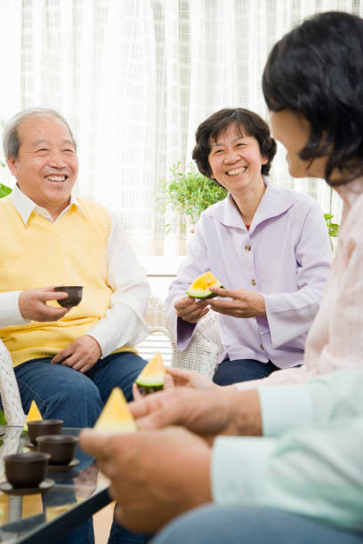 istock Chinese family enjoying fruit and tea 1035201632
