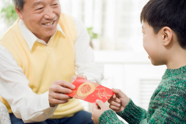 Chinese grandfather giving grandson red pocket