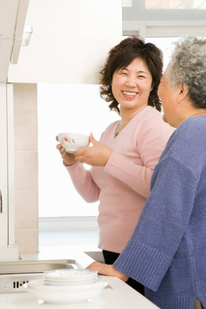 istock Chinese mother and daughter in kitchen 1035202358