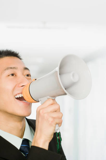 istock Chinese businessman talking into bullhorn 1035208084