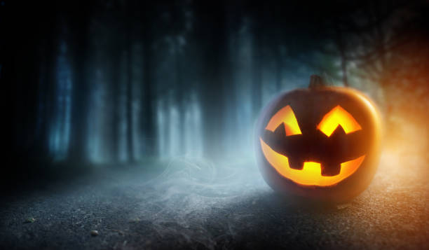 istock Misty Halloween Evening Background With A Pumpkin 1035211030