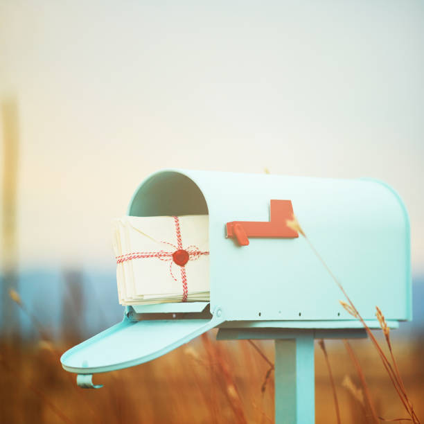 istock Pastel teal mailbox with stack of love letters 1035213248