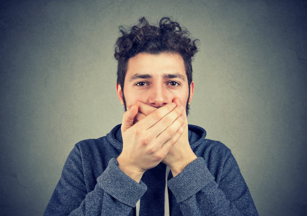 istock Man covering mouth in restriction to talk 1035213570