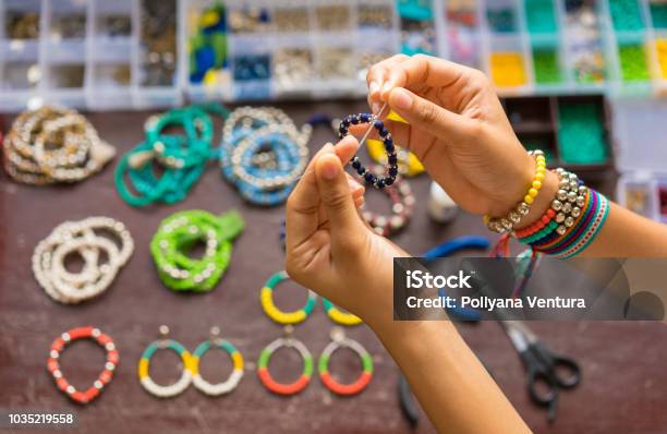 Female Hands Making Handmade Bijouterie With Little Balls And Stones Stock Photo - Download Image Now