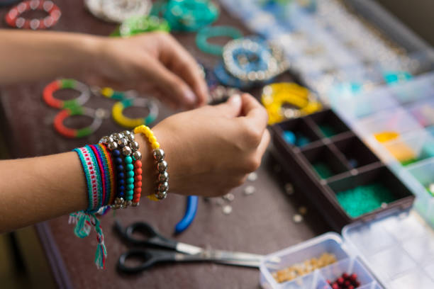 istock Female hands making handmade bijouterie with little balls and stones 1035219600