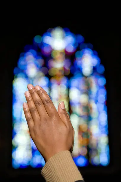 Photo of African lady praying in church