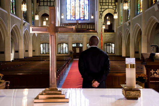 Priest waiting for a sign in church Priest waiting for a sign in church priest photos stock pictures, royalty-free photos & images