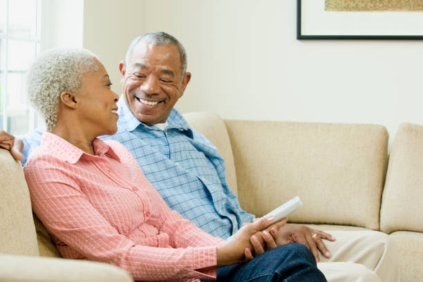istock Black couple sitting in living room 1035222002