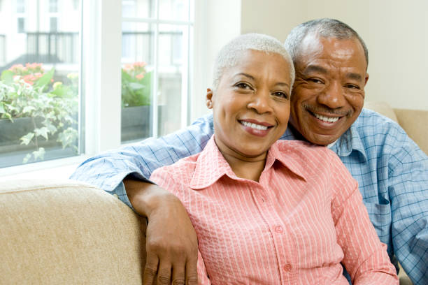 istock African couple hugging in living room 1035222042