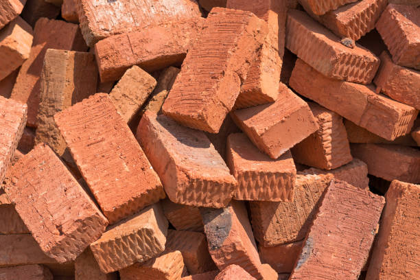 A lot of red bricks are piled up.