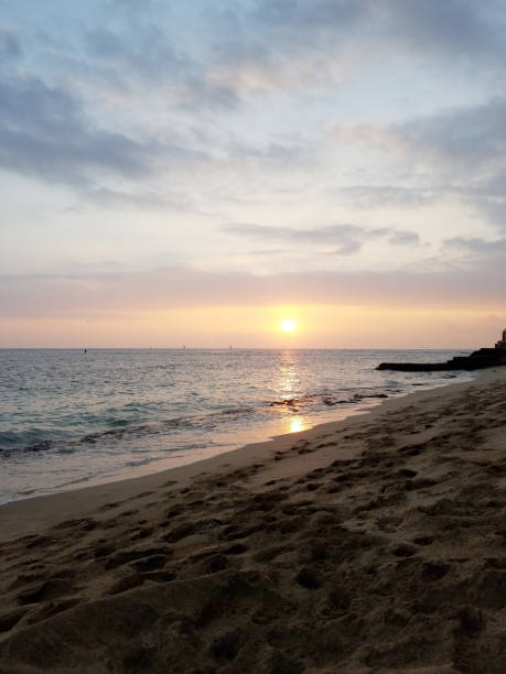istock Sunsets over Waikiki waters as waves roll into shore at Makalei Beach Park 1035227144