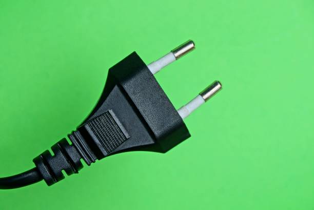 istock black electric plug on the wire on a green background 1035229548