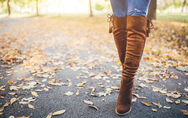 istock Woman walking over fallen leaves 1035234656