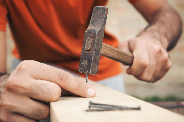 istock Young man painting and fixing wooden board 1035234846