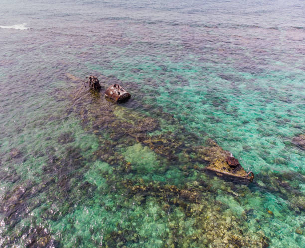 istock Half Submerged Shipwreck on Coral Reef 1035237536