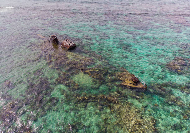 istock Half Submerged Shipwreck on Coral Reef 1035237614