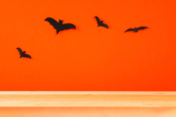 istock The concept for Halloween. Bats on an orange background. Copy space. 1035242416
