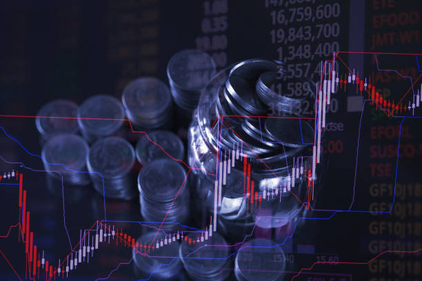 istock Double exposure of coin stack with stock market screen chart board and candle stick for financial business and investor analysis concept. 1035265266