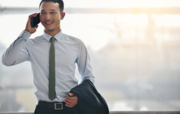 istock Businessman Talking On Mobile Phone In Office 1035269038