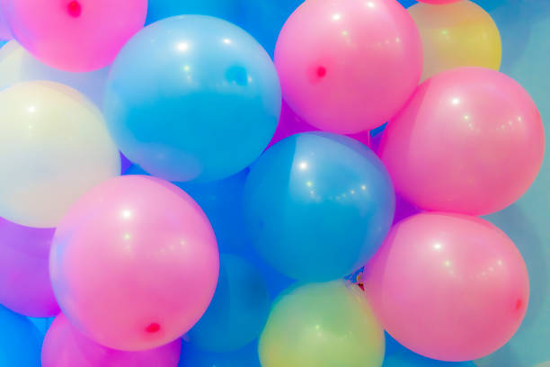 istock Many colorful balloons decorated wall as background 1035275670