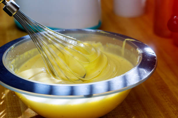istock Mixer over bowl of cookie dough mixing liquid dough for baking 1035290838