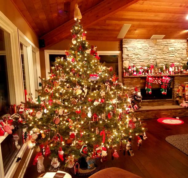 istock Large Holiday Christmas Tree with Stone fireplace in a Rustic Lodge Setting 1035290862