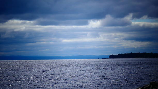 istock Seascape with mountains and trees on the horizon 1035291354