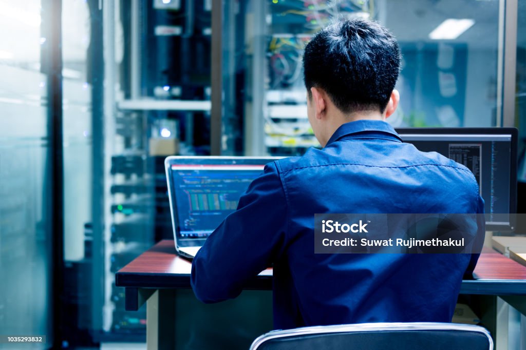 Young IT engineer working at server room is Multi Display, Data Protection Security Privacy Concept. Morality Stock Photo