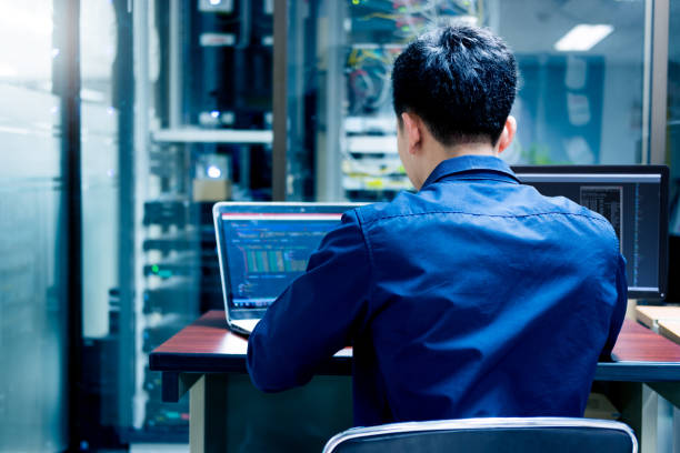 Young IT engineer working at server room is Multi Display, Data Protection Security Privacy Concept. Young IT engineer working at server room is Multi Display, Data Protection Security Privacy Concept. code of ethics stock pictures, royalty-free photos & images