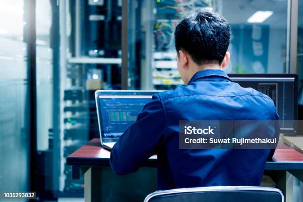 Young It Engineer Working At Server Room Is Multi Display Data Protection Security Privacy Concept Stock Photo - Download Image Now