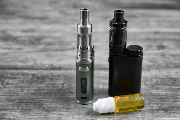 istock E - cigarette for vaping , technical devices.The liquid in the bottle 1035305662