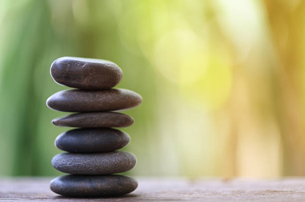 istock Balance Stone on wooden floor and soft sunlight. 1035331366