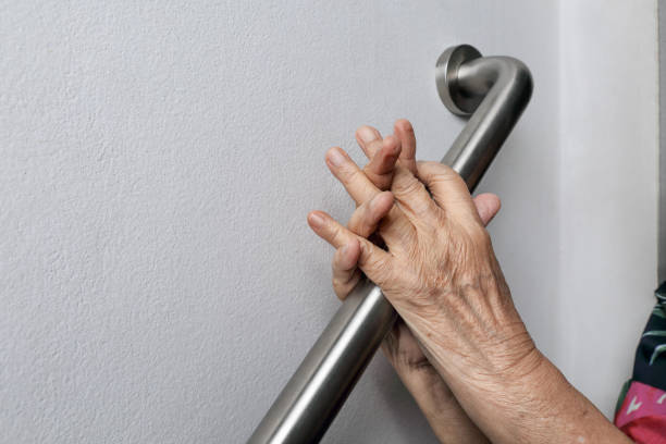 istock Elderly woman holding on handrail for safety walk steps 1035353468