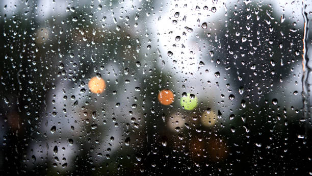 istock rain drops on a window in the blurred background of the beautiful light 1035359838