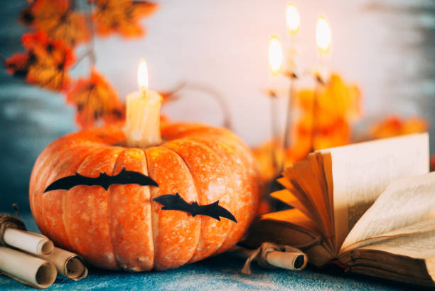 istock Postcard, Halloween background: pumpkins, candles, bats on blue background 1035365298
