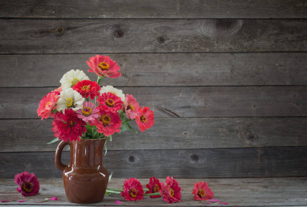 istock flowers in vase on old wooden background 1035383340