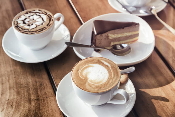 istock Cups of Cappuccino coffee and chocolate mousse cake. Toned image 1035384110
